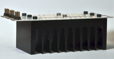 Assembled Luminiaire mounted on an aluminium heatsink, fins facing the table